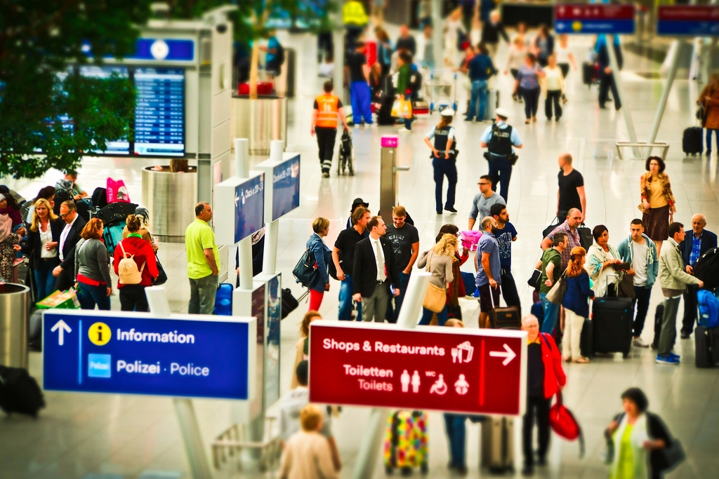 Busy airport, check-in passengers. View