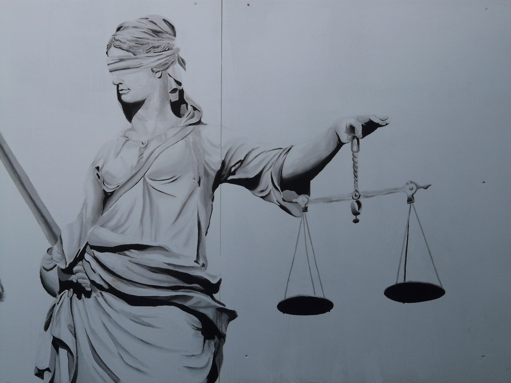 Free woman holding court scale